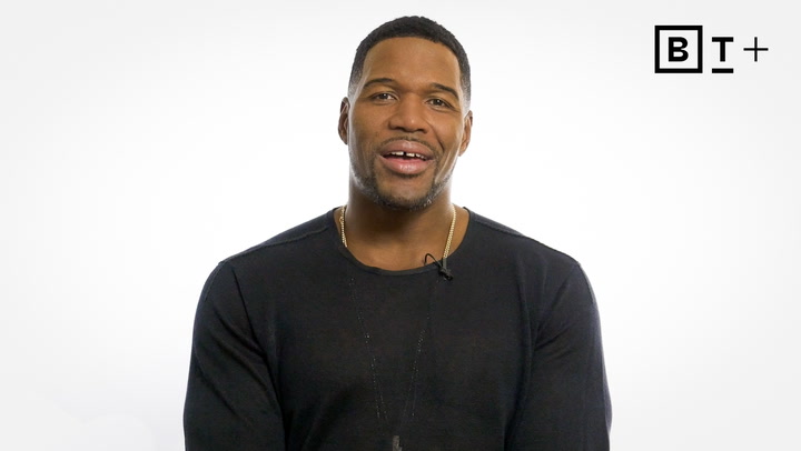 A man wearing a black shirt sits in front of a white background with a "B T +" logo in the top right corner.