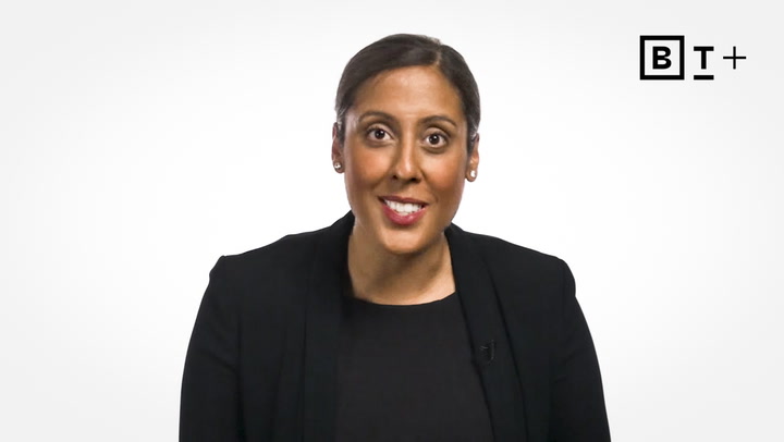 A woman in a black blazer and top speaks while facing the camera, with a BT+ logo in the top right corner against a plain white background.
