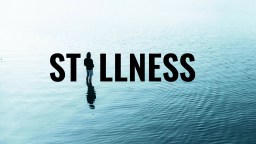A person stands alone on calm water with the word "STILLNESS" in bold letters over the scene.