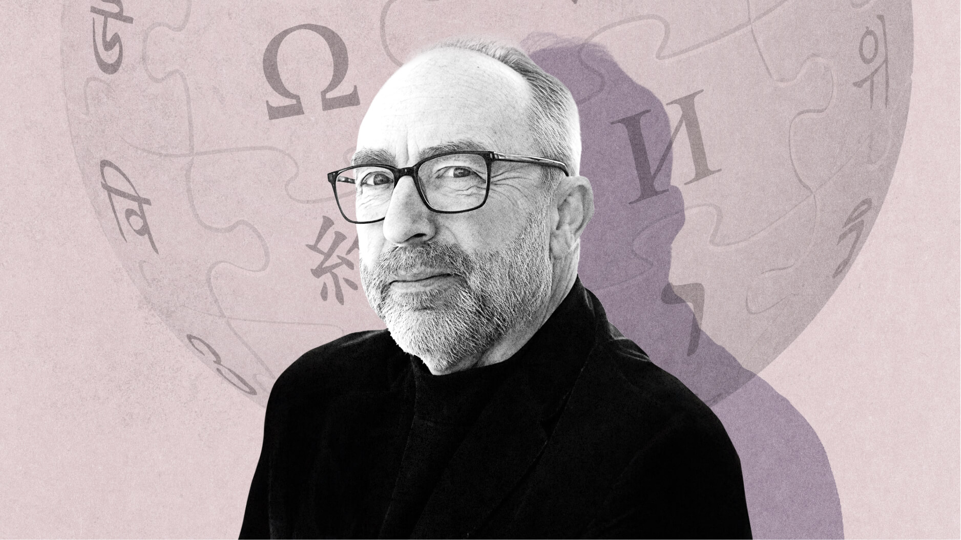 A middle-aged man with glasses and a beard, resembling Jimmy Wales, poses in front of a light-colored background featuring Wikipedia's globe logo and various language characters.