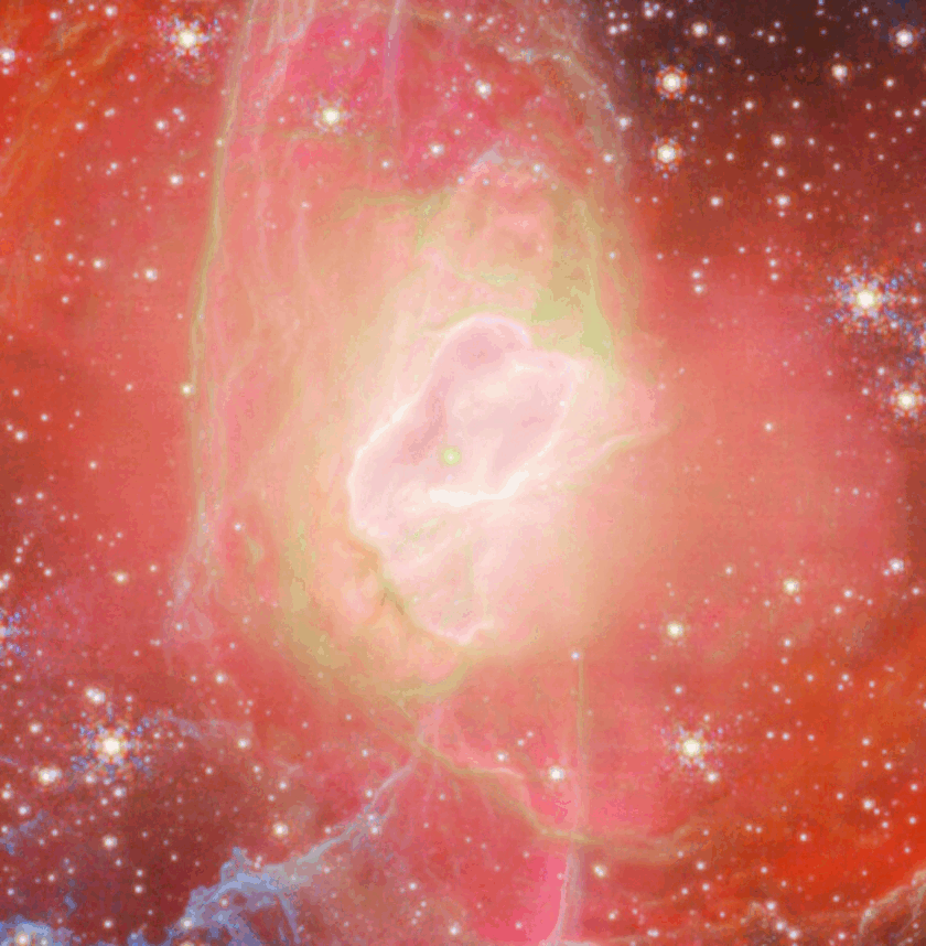 Bright, colorful image of a nebula with a glowing center, surrounded by red, pink, and green gas clouds and scattered stars on a dark background.